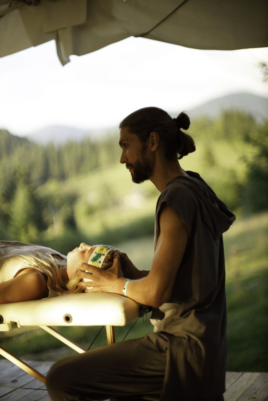 Practitioner working on the head and neck during a session